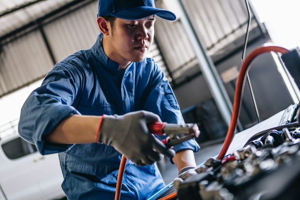 Maintenance worker checking tire service via insurance system at garage